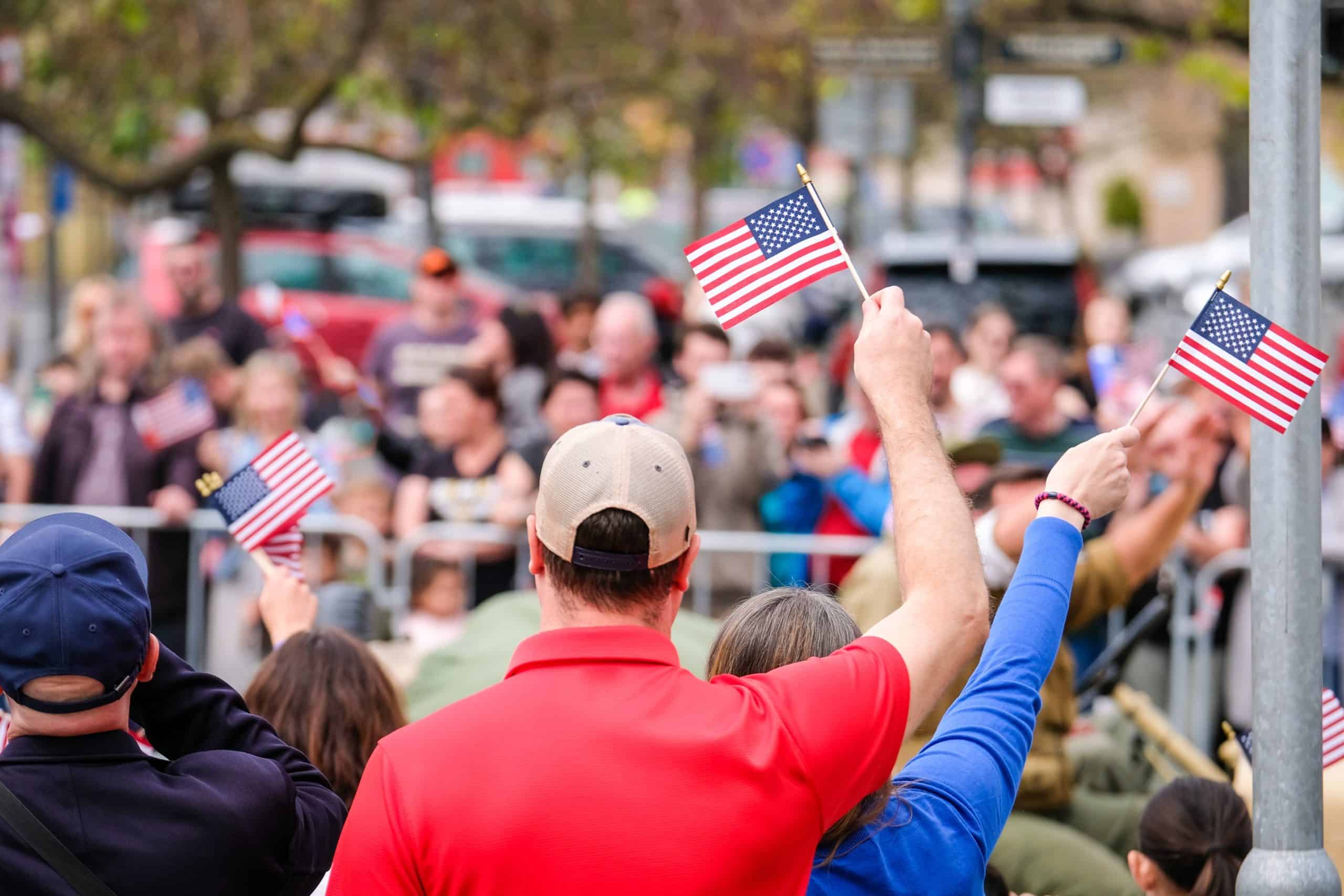 People,Waving,Usa,Flags,In,A,Large,Crowd,At,A